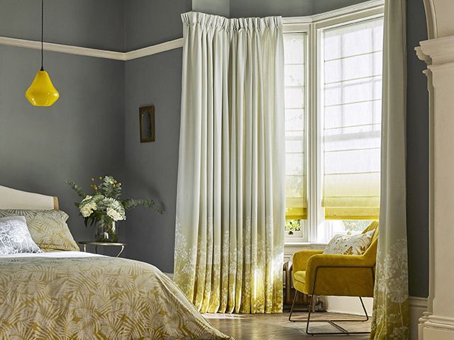 bedroom with yellow ombre curtains and blind - goodhomesmagazine.com