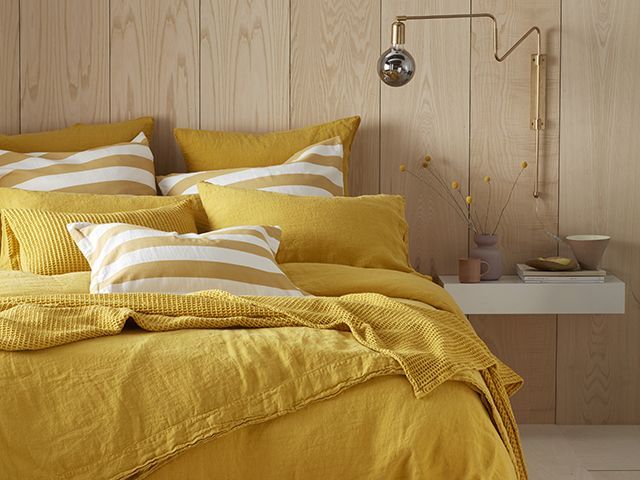 Secret Linen Store linen set in Mustard in wood bedroom - goodhomesmagazine.com