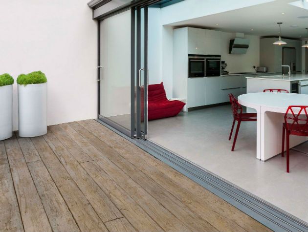 a kitchen dining area opening out onto a decked terrace