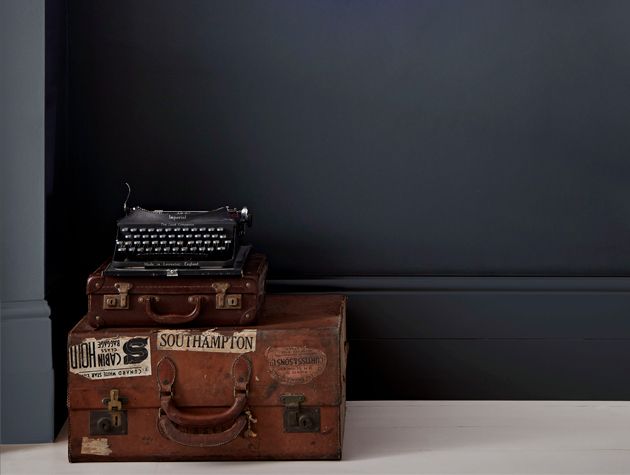 cases and typewriter infront of dark wall