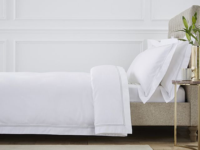 beige bed with white dusk bedding - bedroom - goodhomesmagazine.com