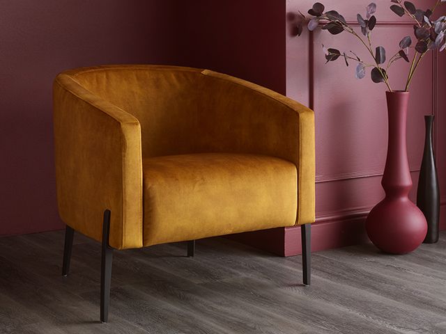 oak furnitureland yellow velvet chair in a red room - inspiration - goodhomesmagazine.com