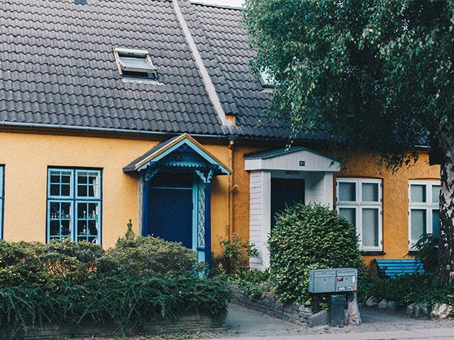 yellow and blue cottage - your home could be worth 65% more if it's on this type of road - news - goodhomesmagazine.com