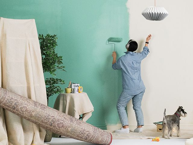 woman painting a room while dancing - inspiration - goodhomesmagazine.com