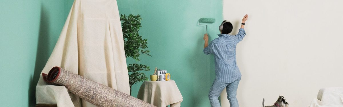 woman painting room while dancing - goodhomesmagazine.com