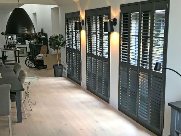 dining area with wooden floor and shuttered windows