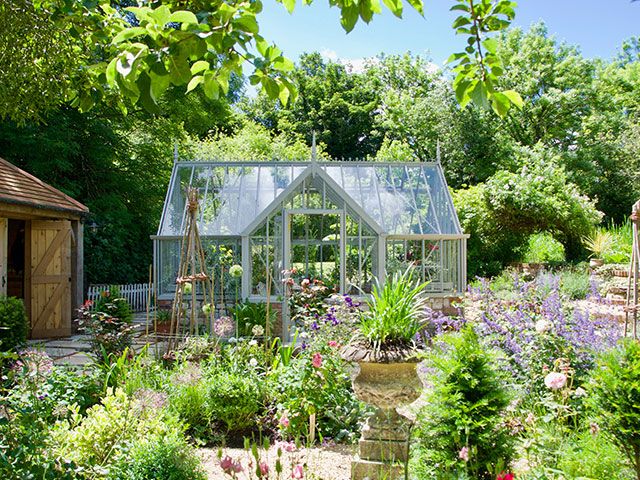 greenhouse in british garden - how a greenhouse can help grow your own veg - garden - goodhomesmagazine.com