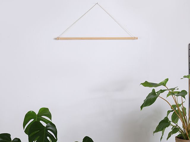 wooden stick on wall - DIY crafting: how to make a tassel wall hanging - inspiration - goodhomesmagazine.com