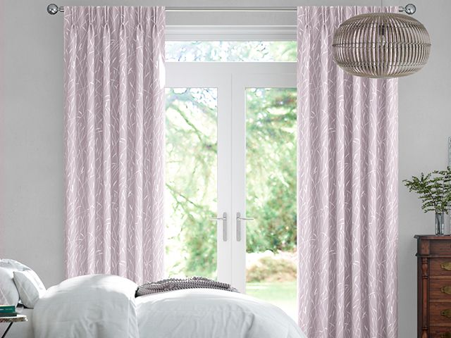 pink curtains in bright bedroom - how to get a perfect nights sleep in warmer months - bedroom - goodhomesmagazine.com