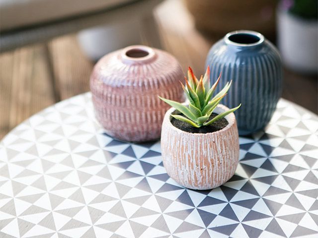pots on sie table - take a tour of this lockdown friendly balcony - inspiration - goodhomesmagazine.com