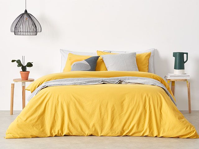 yellow duvet with grey accessories - how to get a perfect nights sleep in warmer months - bedroom - goodhomesmagazine.com