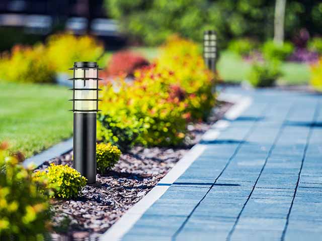 Solar lights beside tiled pathway to save money on energy bills