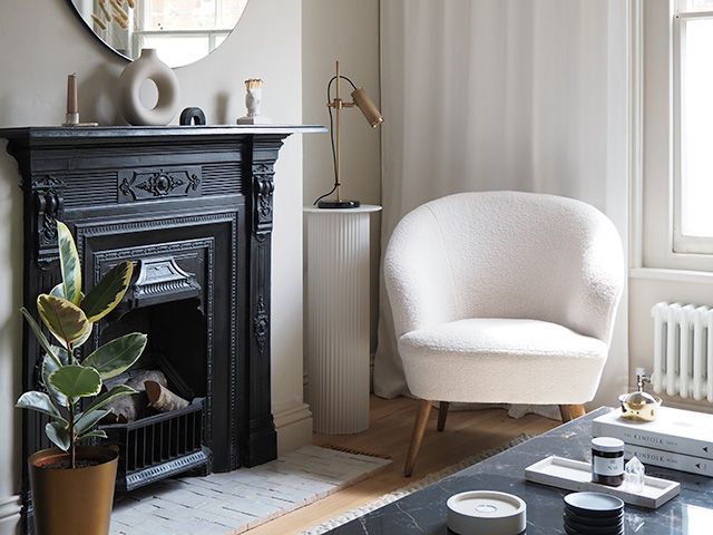 boucle armchair in neutral living room - goodhomesmagazine.com