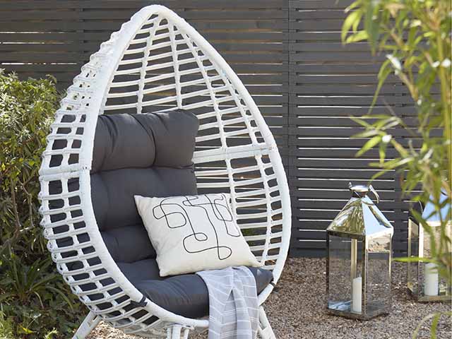 Egg chair with quirky lantern garden accessories, goodhomesmagazine.com