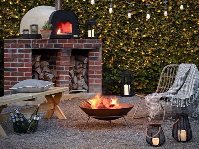 fire pit garden scene - how to bring festival vibes to your garden this summer - garden - goodhomesmagazine.com