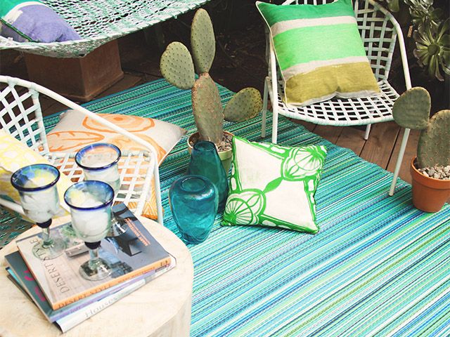 outdoor rug with macrame - how to bring festival vibes to your garden this summer - garden - goodhomesmagazine.com