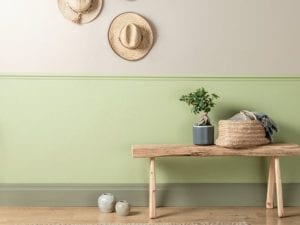 green painted wall in hallway with hats on the wall - news - goodhomesmagazine.com