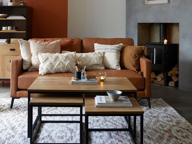 brown leather sofa with beige cushions - 6 ways to reinvigorate a tired sofa - living room - goodhomesmagazine.com