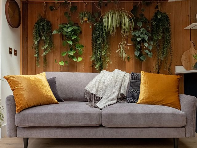 throws and cushions on snug sofa - 6 ways to reinvigorate a tired sofa - living room - goodhomesmagazine.com