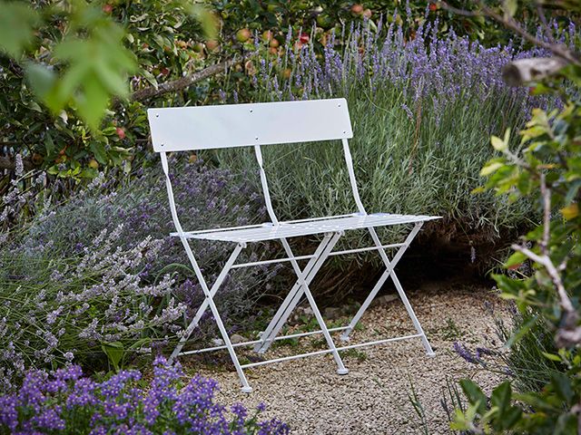 bistro bench among lavender plants - goodhomesmagazine.com - garden
