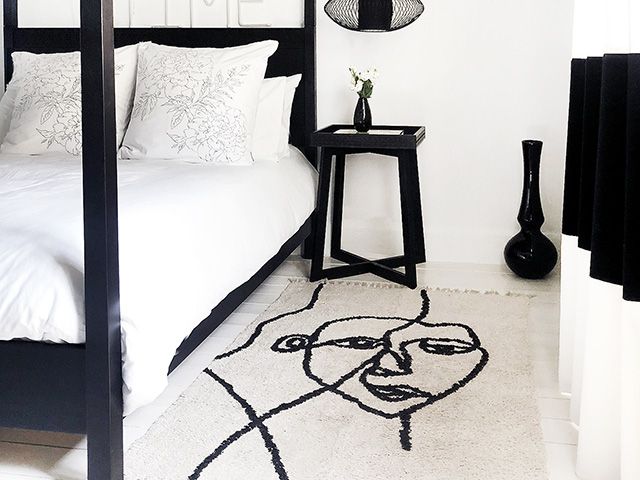 monochrome bedroom with abstract face rug - shopping - goodhomesmagazine.com