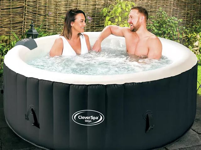 couple enjoying an inflatable spa in the garden