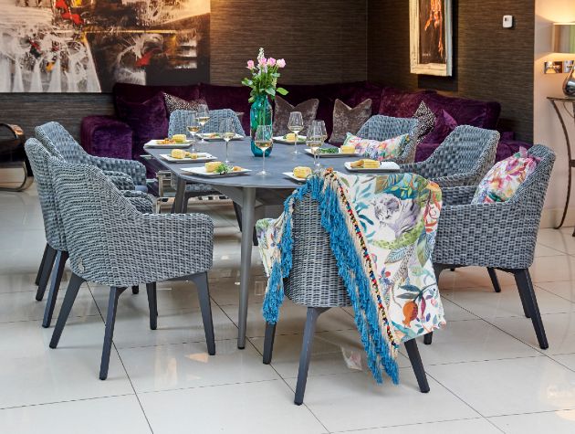 dining room table and chairs with food wine and flowers