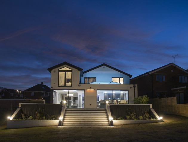 exterior of modern white home seen at night