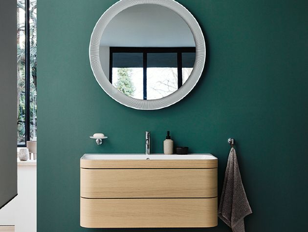 floating vanity unit with mirror on green painted wall