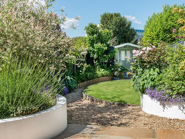 a british garden with raised beds of planting - garden - goodhomesmagazine.com