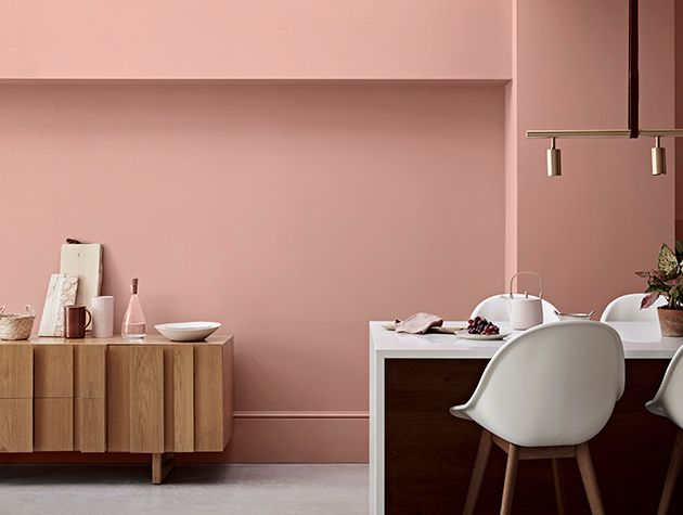 modern furniture in front of wall painted pink