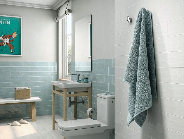 modern tiled bathroom with towel hanging in foreground
