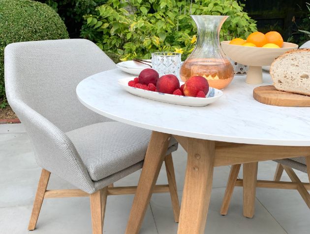 outdoor table and chairs with fruit drink and bread