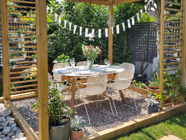 table and chairs under a pergola