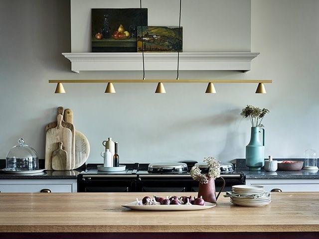 red kitchen with gold pendant light - goodhomesmagazine.com