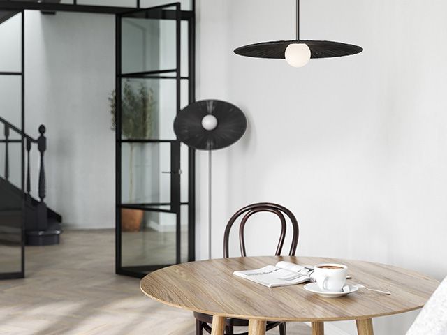 dining table with modern black lighting - goodhomesmagazine.com