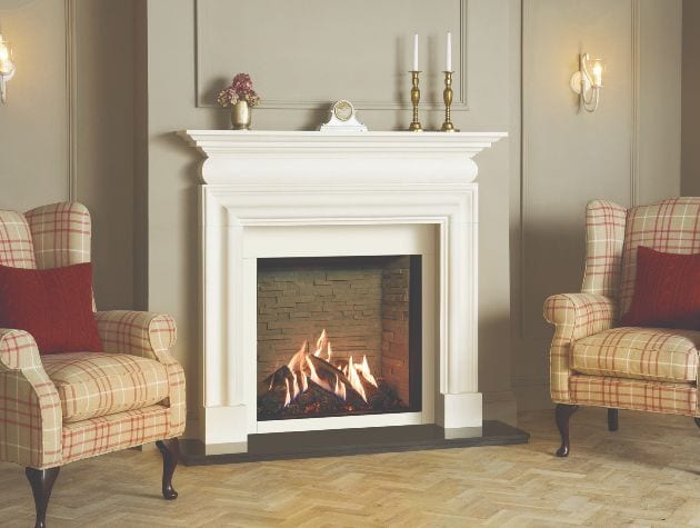 fireplace with log effect gas fire and an armchair either side