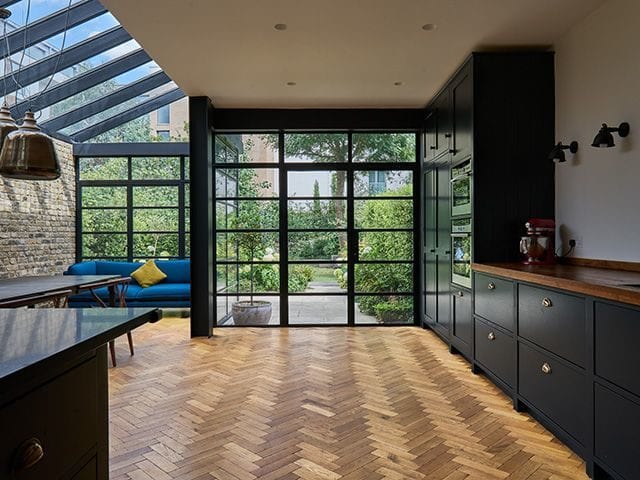 havwoods kitchen herringbone flooring with crittall doors - goodhomesmagazine.com