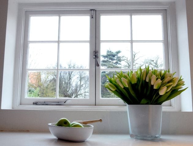 interior casement window with flowers in vase and fruit bowl 1