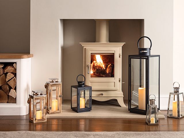 lanterns round fireplace - fireplace design ideas for a cosy home - living room - goodhomesmagazine.com