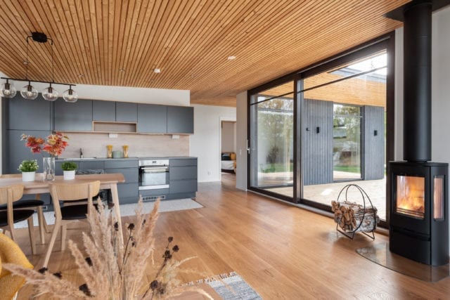 open plan kitchen and dining room with log burner and patio doors