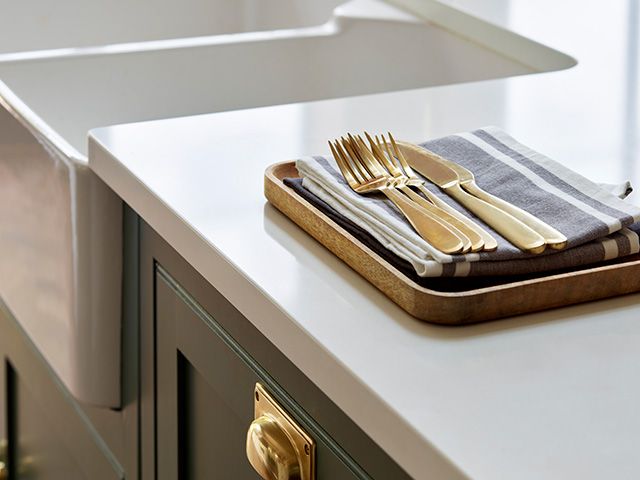 white quartz worktops in kitchen with green cabinetry - goodhomesmagazine.com