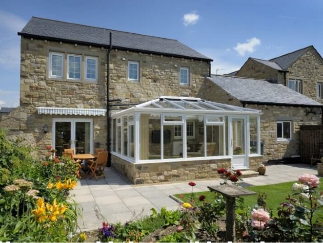 Stone house with conservatory and flower garden