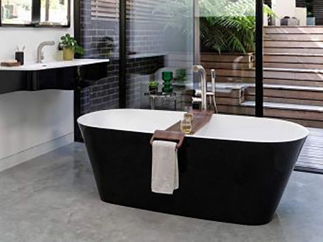 stylish black double ended bath in bathroom - goodhomesmagazine.com