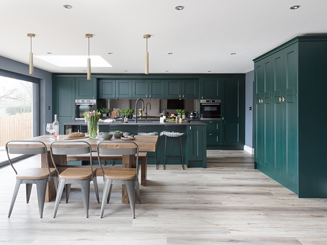 kitchen in dark green, wooden chair and tables