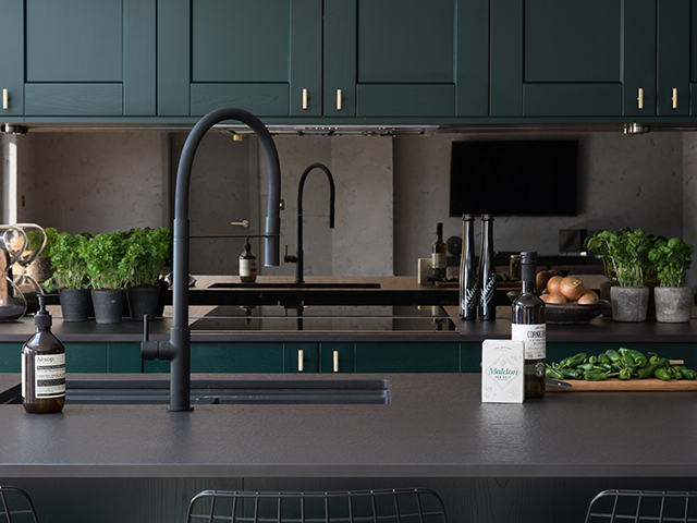 kitchen worktop with sink, tap, food and wine