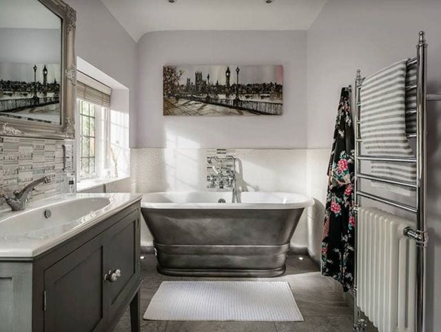 bathroom with nickel bath tub - goodhomesmagazine.com