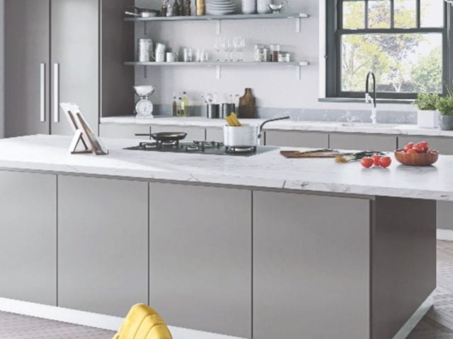 grey kitchen with marble worktop and seating