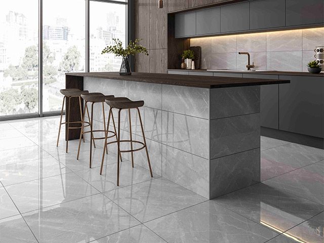 grey marble used throughout a kitchen from the floor to the kitchen island and splashback