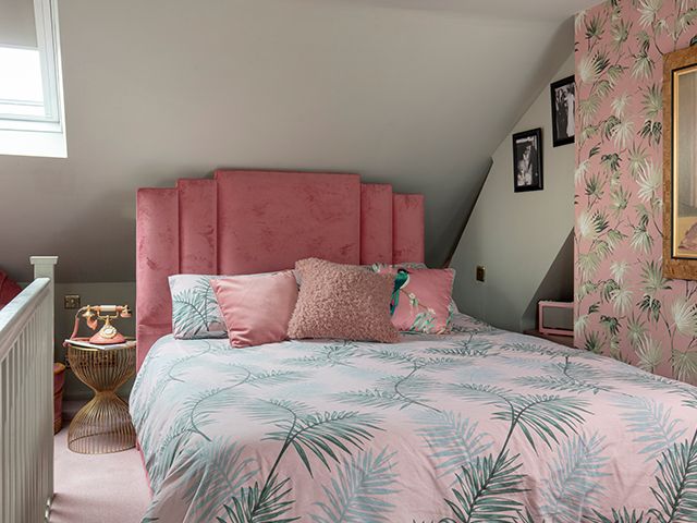  loft conversion bedroom with pink and palm print bedding and wallpaper